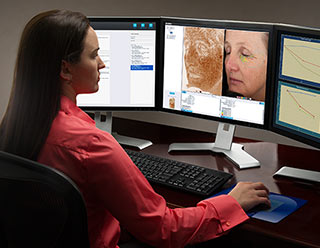 A medical professional using Canfield's research system on a computer